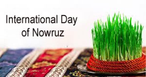 wheatgrass and colorful piece of cloth kept on a table International Day of Nowruz